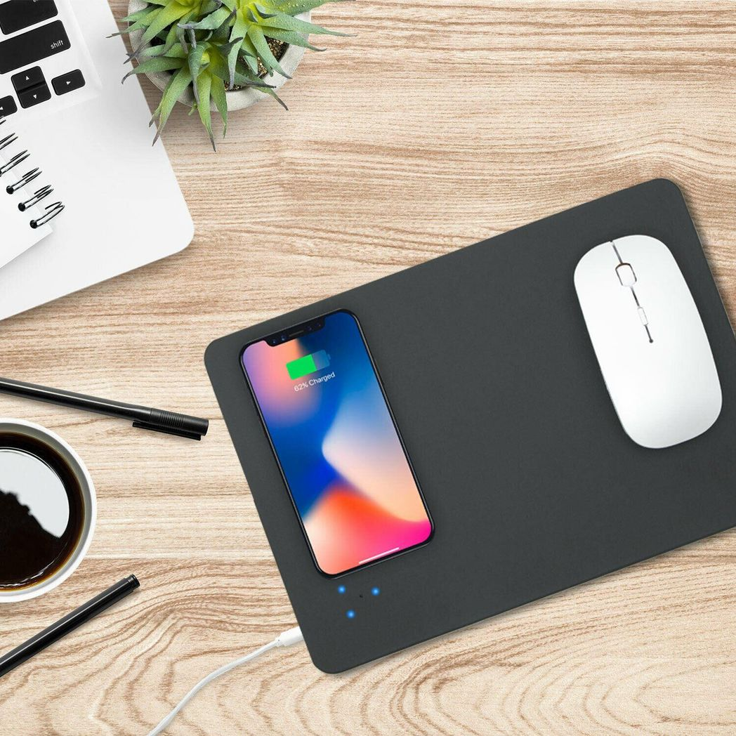 Black desk mat with smartphone, mouse, and coffee on a wooden desk